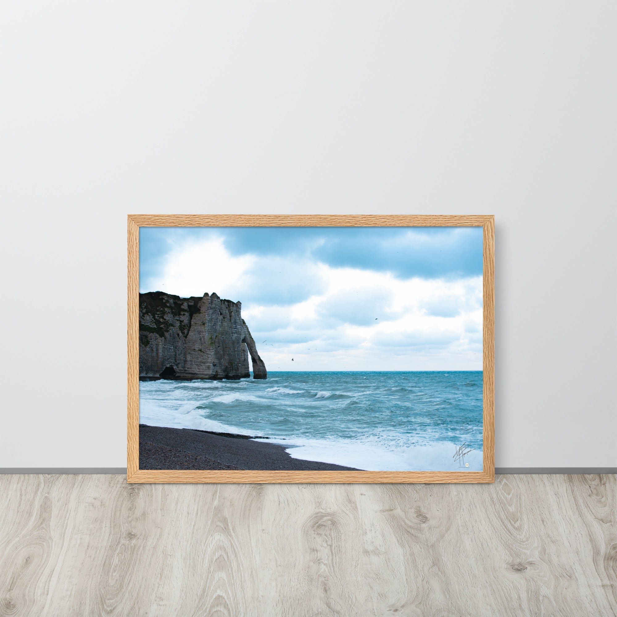 Photographie apaisante de la plage d'Etretat, où la mer caresse le rivage sous un ciel clair. Une représentation parfaite de la tranquillité et de la beauté naturelle de la côte normande.
