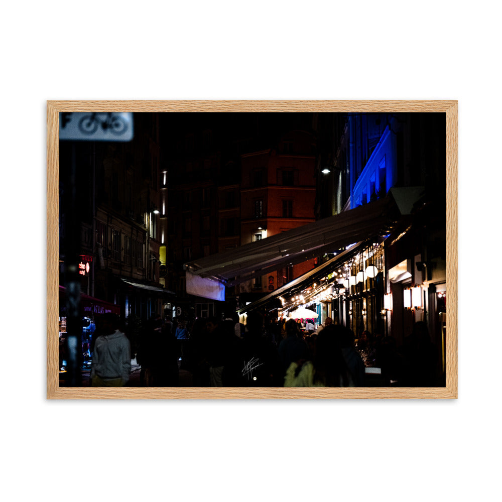 Rue animée de Paris la nuit, illuminée par des éclairages doux, encadrée d'un bois de chêne.