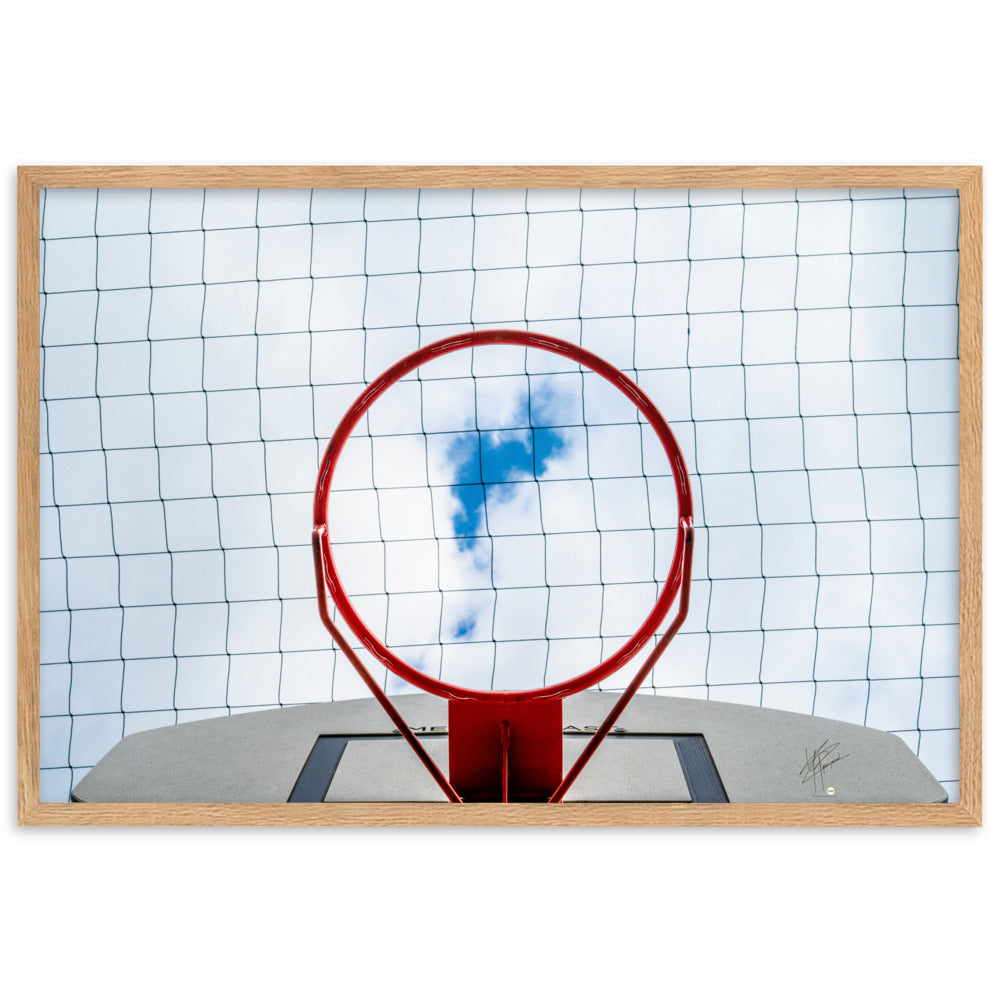 Vue en contre-plongée d'un panier de basket-ball, encadrant une échappée bleue dans un ciel nuageux, une interprétation artistique du jeu dans les cieux.