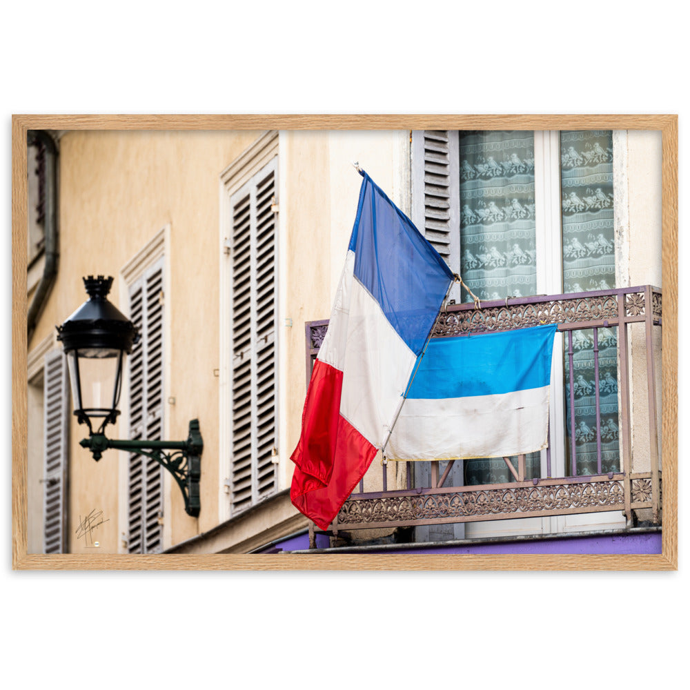 Photographie du drapeau tricolore français suspendu à un garde-corps métallique, représentant à la fois la tradition et la modernité, encadrée pour une mise en valeur murale.