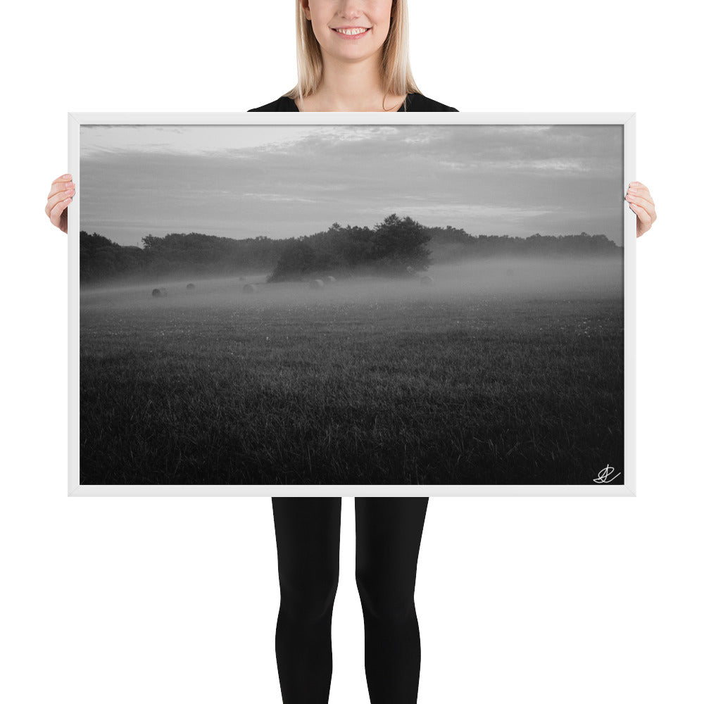 Photographie noir et blanc 'Brouillard' par Ilan Shoham, mettant en scène un paisible champ tourangeau où des ballots de paille émergent majestueusement du brouillard, incarnant la sérénité et la beauté mystique de la campagne française.