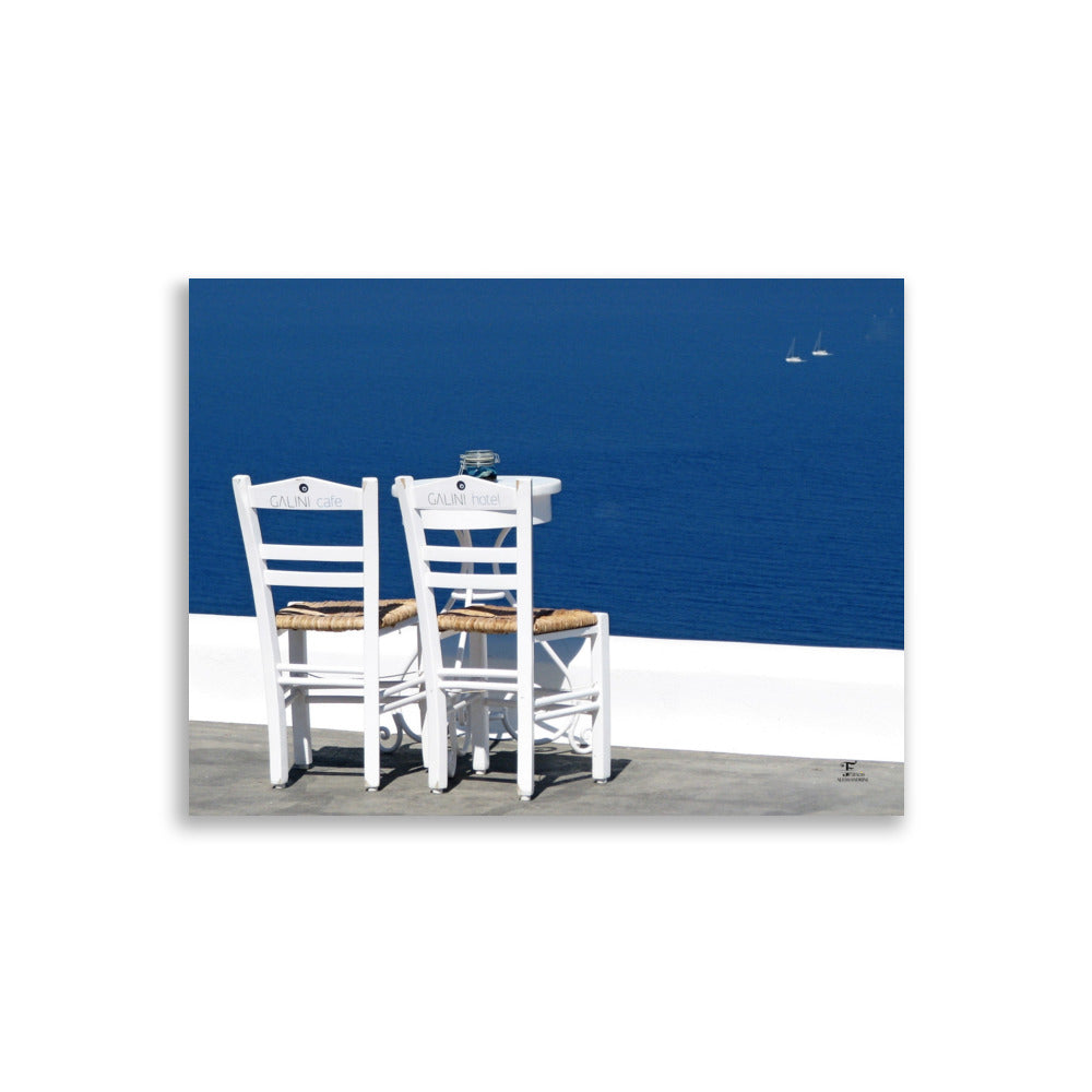 Photographie de santorin avec deux chaises en bord de mer