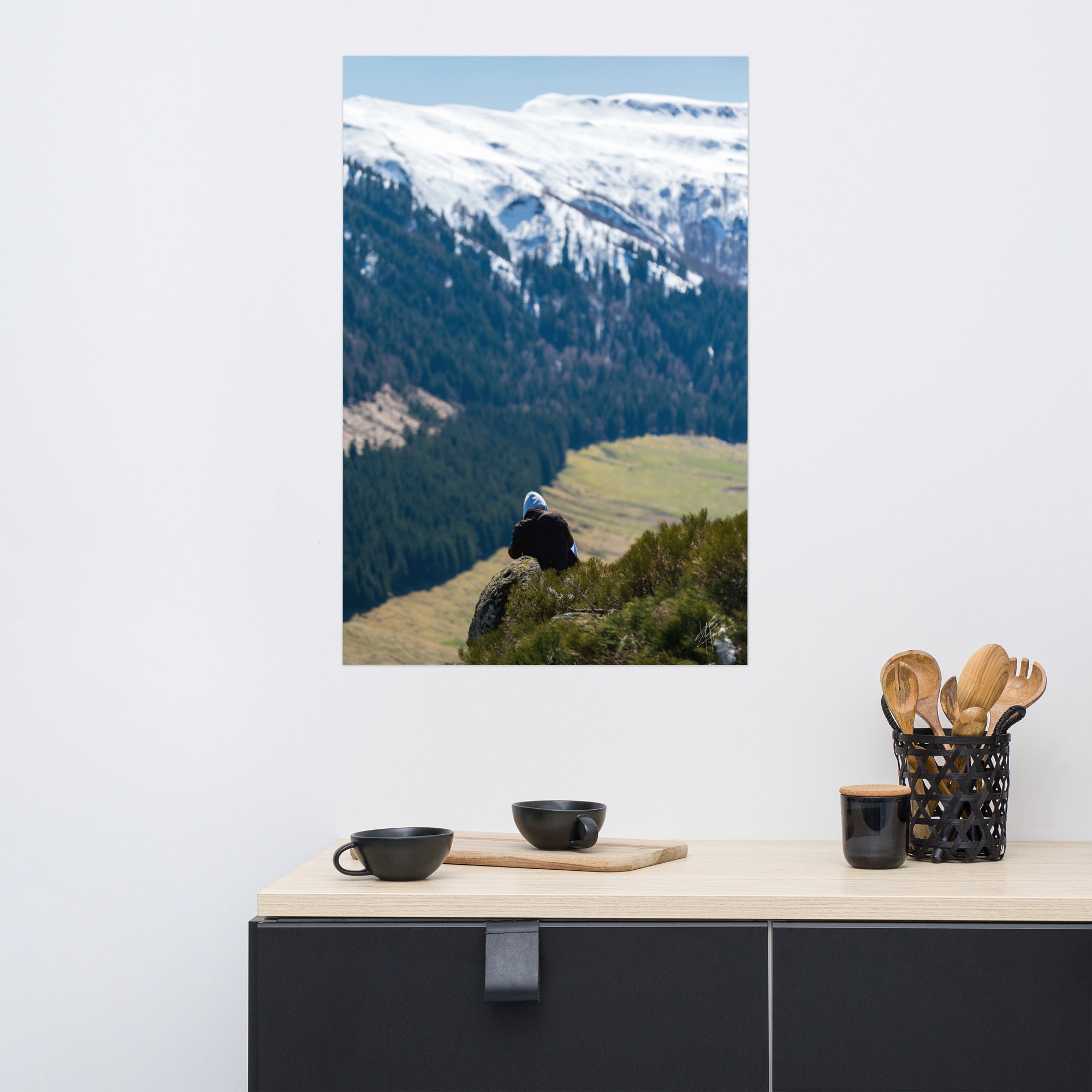 Figure en méditation sur une montagne du Cantal, vaste paysage en arrière-plan.