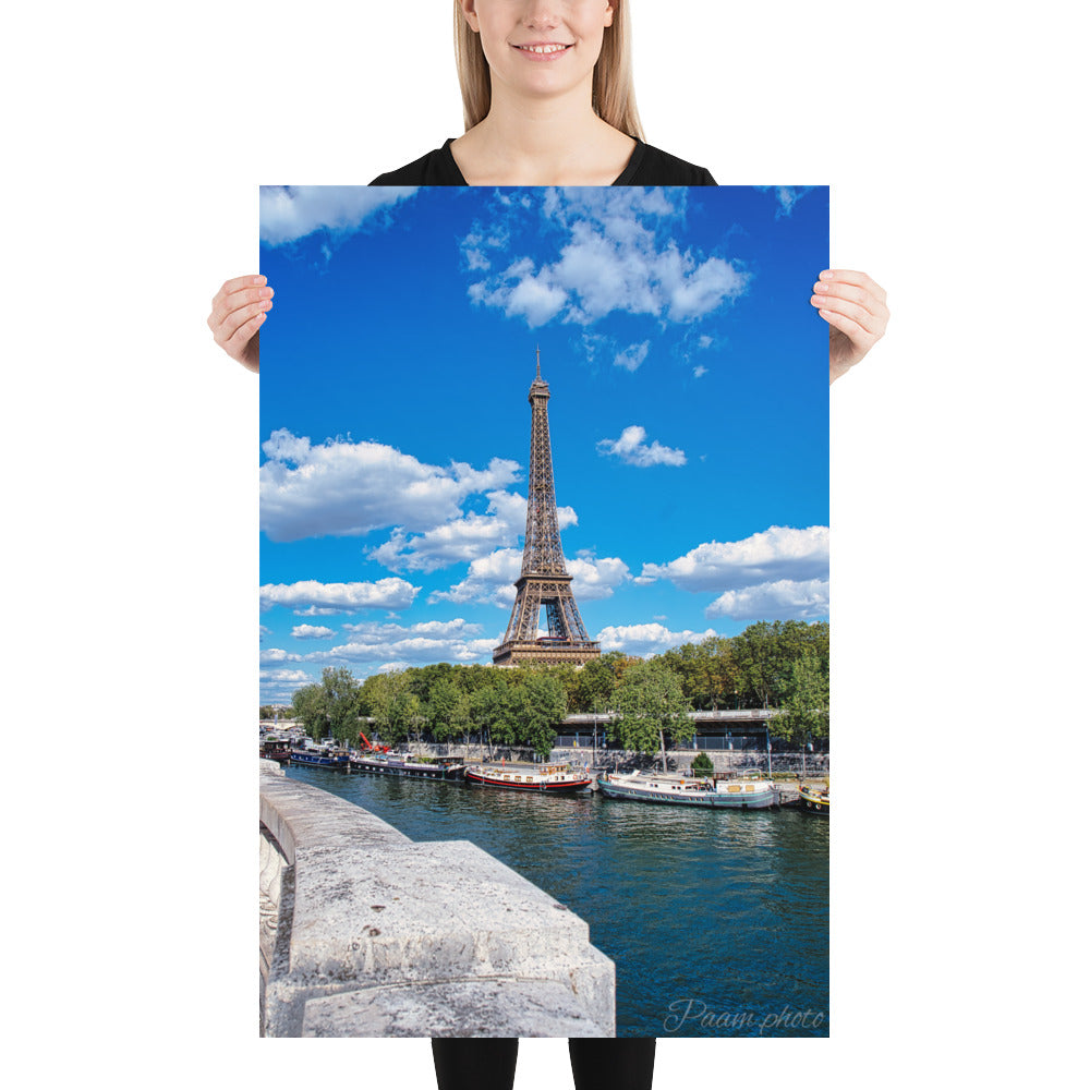 Vue panoramique de la Tour Eiffel et des péniches sur la Seine, sous un ciel bleu nuageux – une œuvre signée Antony Porlier.