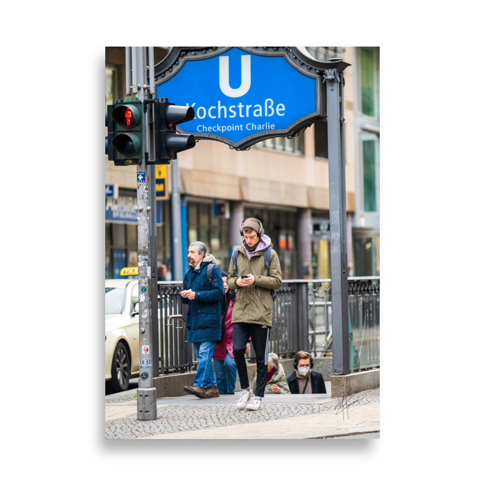 Sortie de métro 'Checkpoint Charlie' à Berlin, illustrant le contraste entre l'historique et le moderne.